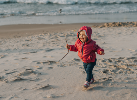 Young child playing on ocean beach